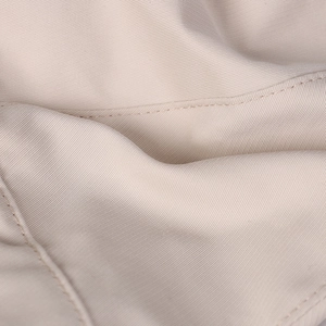 Macro detail of fine twill fabric and uniform stitching on a beige sun hat
