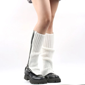 Close-up of white knit leg warmers featuring stylish side zipper and textured fabric