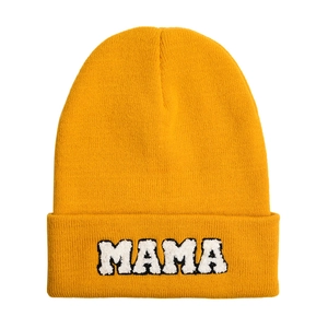 Detail of yellow knit beanie featuring MAMA chenille embroidery and ribbed texture
