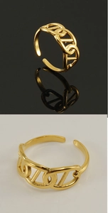 Detail of golden hollow chain ring with adjustable opening on reflective surface