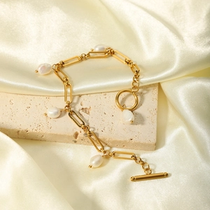 Baroque freshwater pearl bracelet with 18K gold-plated OT buckle on silk background