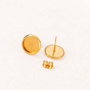 Pair of gold stainless steel round stud earring blanks with backs on white background