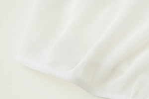 Close-up of white breathable mesh fabric detail and professional stitching on the shirt
