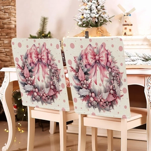 Pink Christmas chair covers with festive wreaths and bows in a cozy holiday dining room