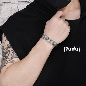 Close-up of a men's punk bracelet featuring multi-layer silver chains and black leather
