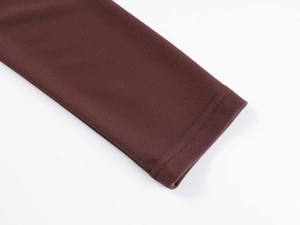Close-up detail of the sleeve cuffs and stitching on the dark brown fitness long sleeve shirt