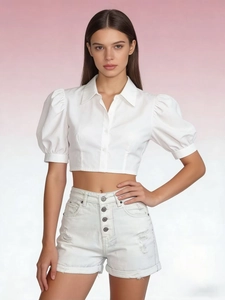 Front view of white puff sleeve shirt with row buttons and distressed denim shorts