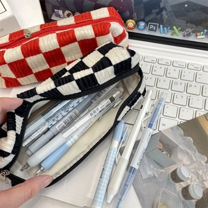 Close-up of checkered corduroy pencil case with large capacity and soft texture