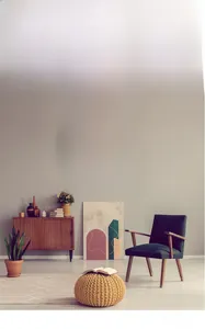 Detail view of a mint green wall clock with gold numerals in a modern living room setting