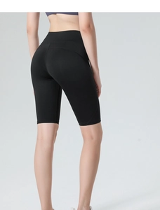 Close-up of black high-waisted yoga shorts with ergonomic curved seams and elastic fabric