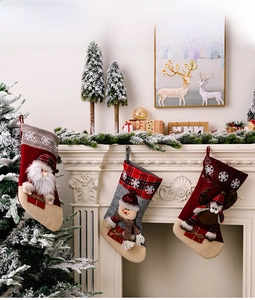 Close-up of Santa, Snowman and Reindeer Christmas stockings on a festive fireplace