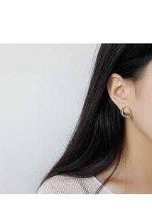 Close-up of minimalist S925 sterling silver geometric double ring stud earrings on model