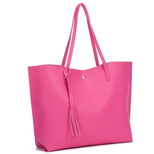 Detail view of pink litchi grain PU leather tote bag with stylish fringe tassel