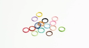Close-up of colorful metal jump rings in assorted vibrant shades for DIY jewelry making