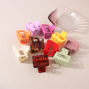 Detailed close-up of 5cm square shark hair clips in assorted macaron and tortoise colors