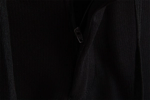 Close-up of high-quality black metal zipper on premium textured men's business trousers