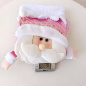 Detail view of a pink plush Nordic Christmas stocking with a 3D Santa Claus figure