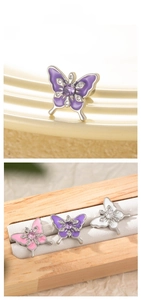 Macro view of butterfly earrings with colorful enamel finish and sparkling crystals