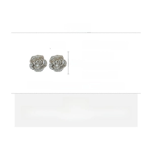 Detail view of rhinestone flower earrings with size specs and silver needle material