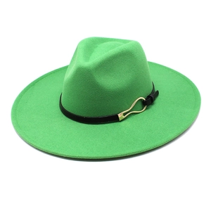 Detail of green felt fedora hat featuring black leather band and gold metal buckle