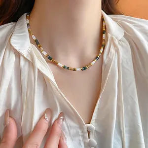 Elegant gold-plated shell freshwater pearl necklace on model with vintage aesthetic