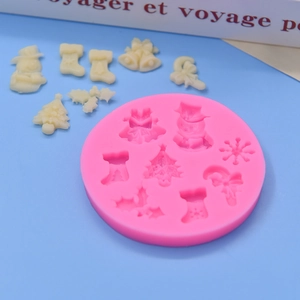 Pink silicone Christmas mold with snowman and tree shapes for DIY cake baking and chocolate