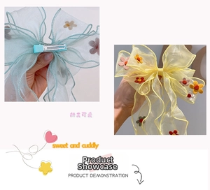 Detail of organza bow hair clip with embroidered flowers and metal alligator grip