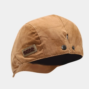 Vintage brown canvas flat cap with leather brand patch and metal button detail