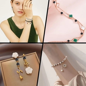 Detailed view of gold beaded bracelets and clover necklaces with pearl elements