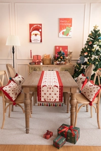 Detailed view of Christmas reindeer table runner with tassels and matching festive pillows