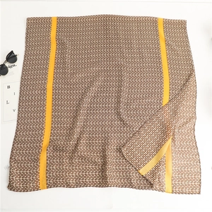 Detailed texture of geometric pattern scarf with striking yellow stripes on soft fabric