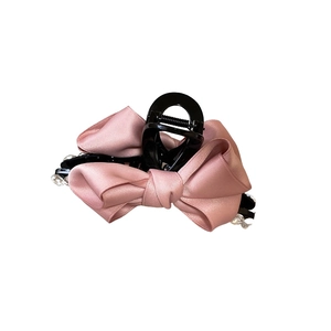 Pink satin ribbon bow hair claw clip with crystal rhinestones on a white background