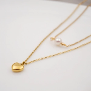 Double-layered gold titanium necklace with minimalist heart pendant and white pearl charm