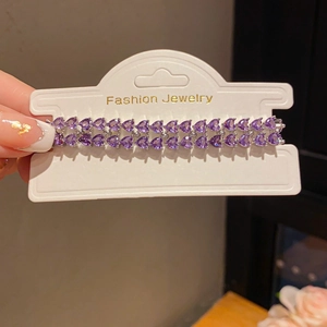 Detail of double-row purple heart gemstones set in silver alloy bracelet fashion jewelry