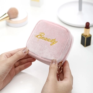 Pink velvet mini lipstick pouch with gold Beauty embroidery and circular zipper pull