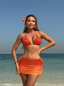 Detail of bright orange crochet bikini top and matching gradient mesh drawstring beach skirt