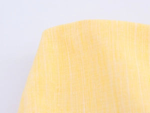 Macro shot of yellow linen-cotton woven fabric showing high-quality texture and fiber