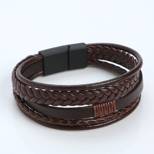 Detail view of multi-layer braided brown leather bracelet with black magnetic clasp