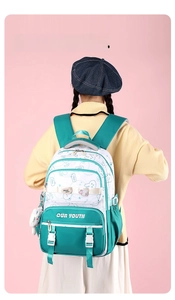 Detail of green student backpack with cute cartoon rabbit and plush doll charm