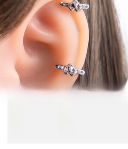 Detail view of silver heart buckle ear cuff on model with material specifications