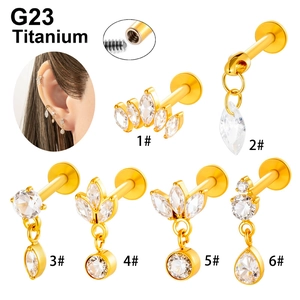 G23 titanium golden piercing studs in various luxury designs shown with model wear