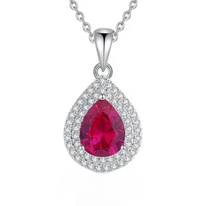 Macro detail of S925 silver pear-shaped red ruby pendant necklace with halo stones