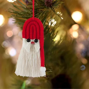 Handmade woven Santa Claus ornament with red fringe and beads on a Christmas tree