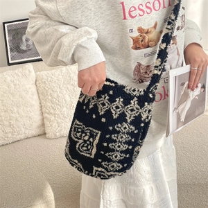 Model wearing a fuzzy leopard print shoulder bag with thick woven straps in a cozy setting