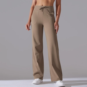 Detail of high waist drawstring wide leg yoga pants with side pockets in khaki color