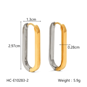 Detailed view of two-tone 18K gold and silver oval earrings with exact size measurements