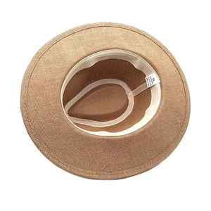 Detail view of woven Panama hat interior with size 58 label and paper straw texture