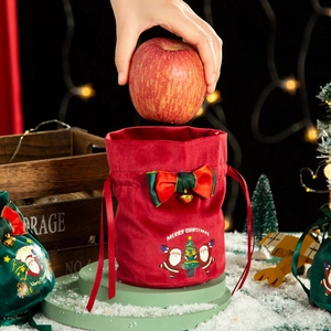 Red velvet Christmas drawstring gift bag with Santa Claus embroidery and a gold bell bow