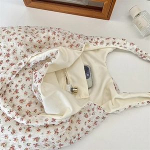 Interior view of floral canvas shoulder bag featuring a convenient inner zipper pocket