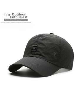 Close-up of black breathable baseball cap with perforated fabric and square patch